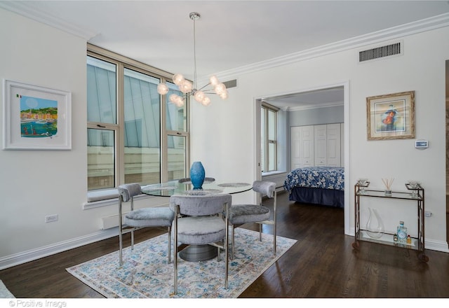 dining room with crown molding, a chandelier, and dark wood-type flooring