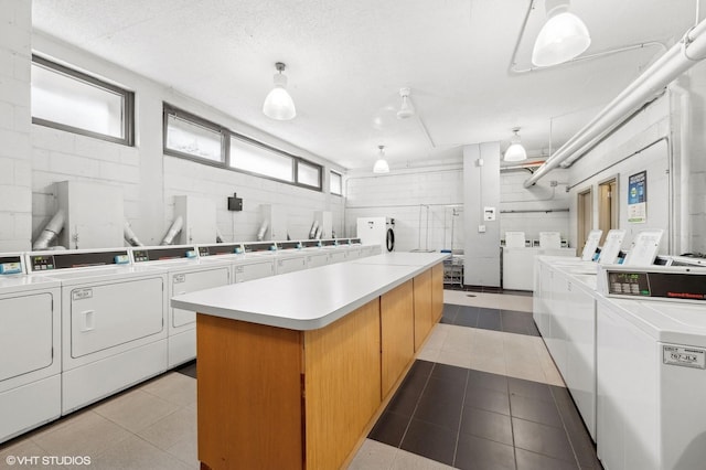 laundry area with light tile patterned flooring and separate washer and dryer