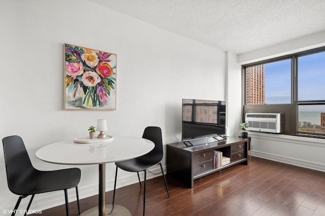 interior space featuring cooling unit, dark hardwood / wood-style floors, and a textured ceiling