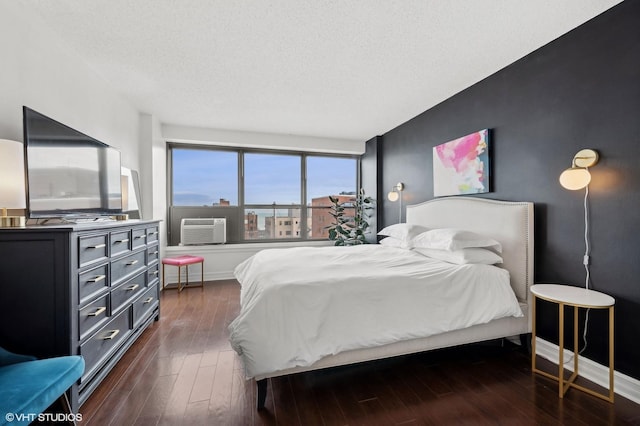 bedroom with dark wood-type flooring and a textured ceiling