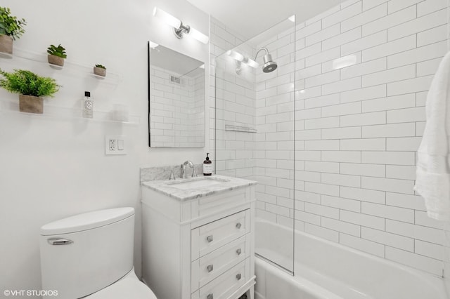 full bathroom featuring vanity, toilet, and tiled shower / bath combo