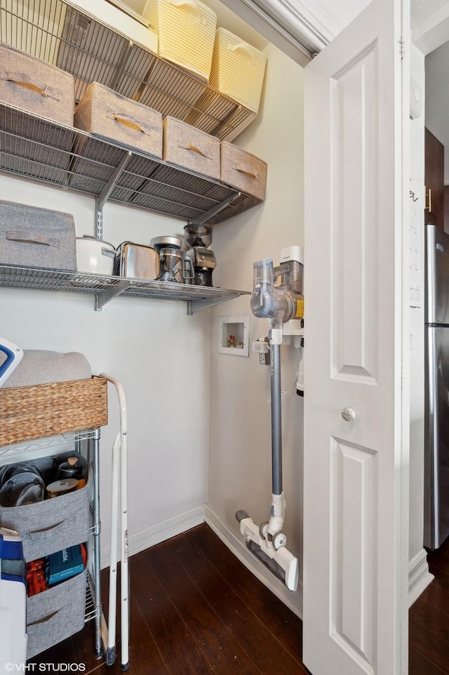 laundry area featuring washer hookup and dark hardwood / wood-style flooring