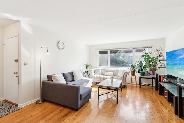 living room with light wood-type flooring and baseboards