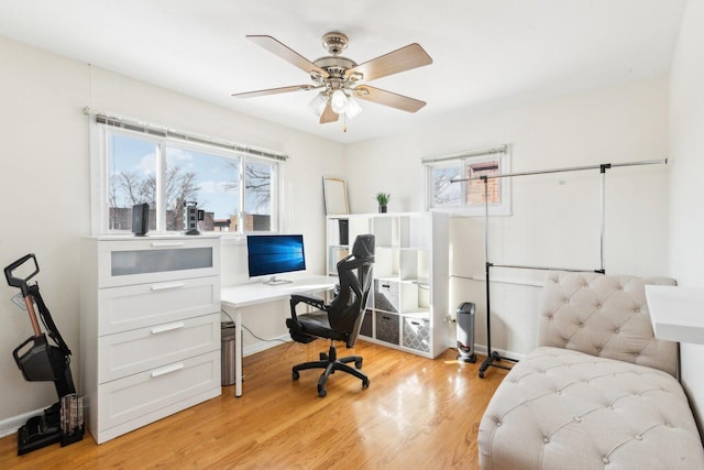 office space with a ceiling fan and light wood-style floors