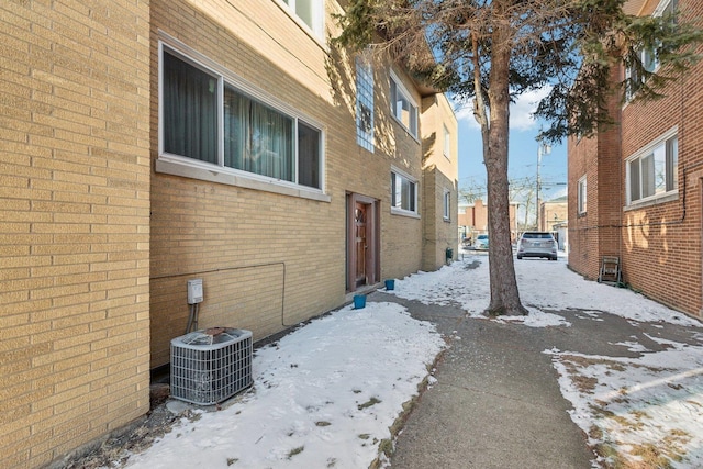 8307 N Christiana Ave Unit 2W, Skokie, IL 60076 - snow covered property featuring central air condition unit and brick siding