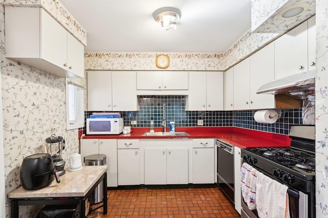 8307 N Christiana Ave Unit 2W, Skokie, IL 60076 - kitchen featuring gas stove, a sink, under cabinet range hood, white microwave, and dishwashing machine