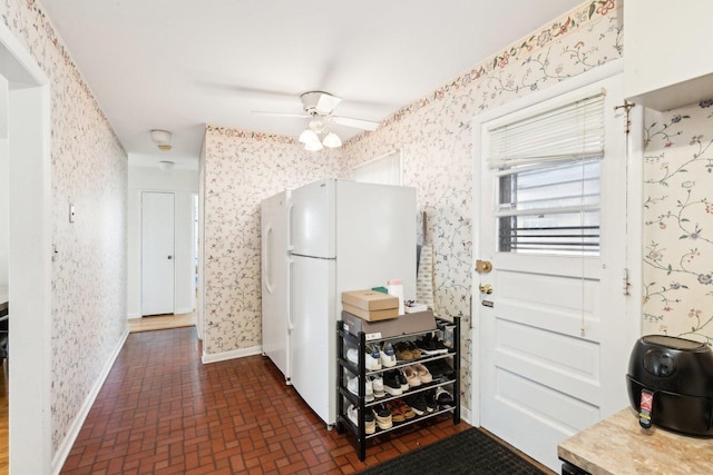 8307 N Christiana Ave Unit 2W, Skokie, IL 60076 - kitchen featuring wallpapered walls, brick patterned flooring, freestanding refrigerator, and a ceiling fan