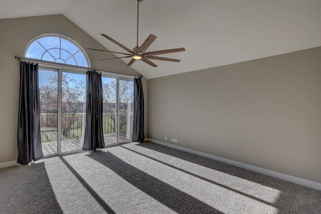 empty room featuring lofted ceiling, ceiling fan, carpet floors, and a healthy amount of sunlight