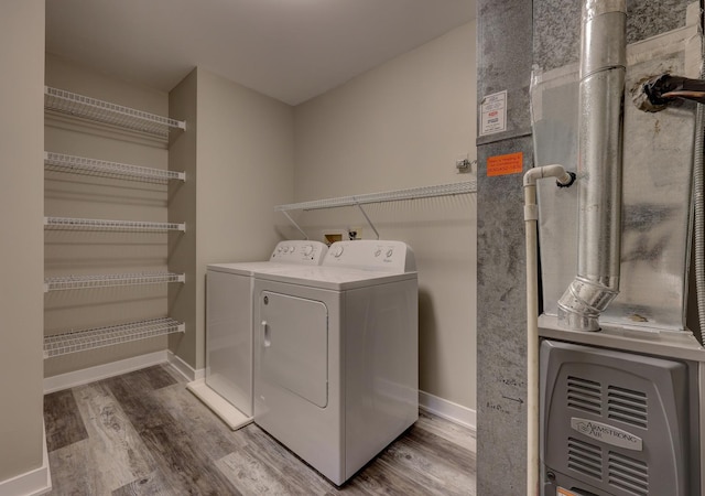 laundry area featuring wood-type flooring and independent washer and dryer