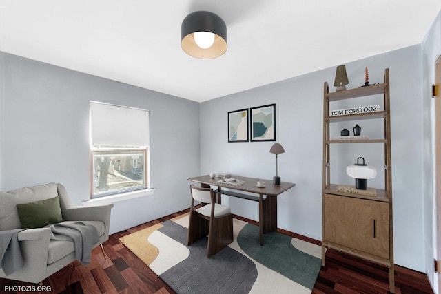 home office with baseboards and wood finished floors