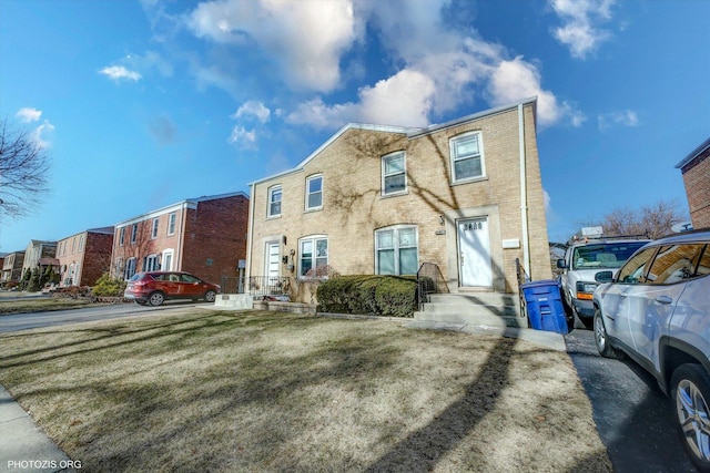 townhome / multi-family property with brick siding