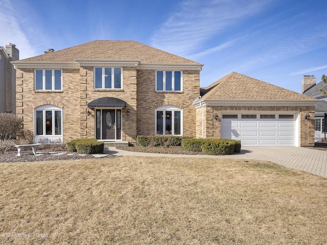 view of front facade with a garage and a front lawn