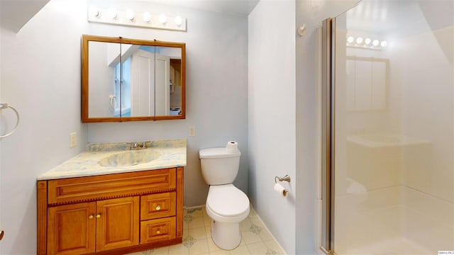 bathroom featuring vanity, an enclosed shower, and toilet