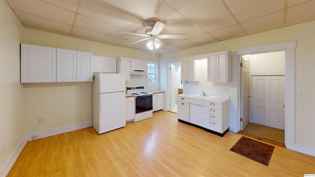 kitchen with sink, white appliances, light hardwood / wood-style floors, and white cabinets