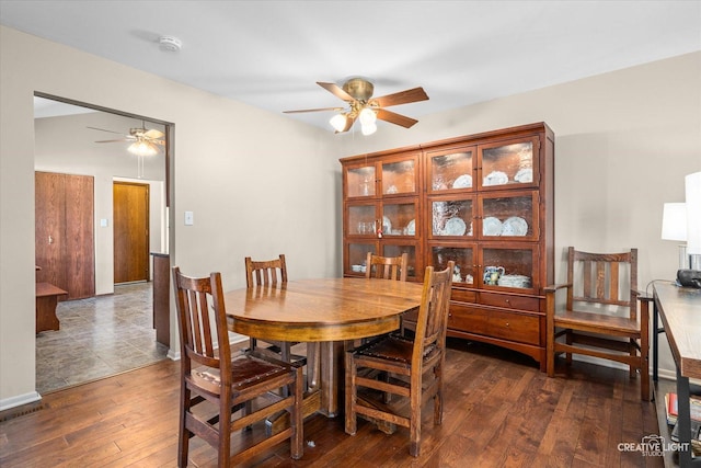 dining space with ceiling fan and dark hardwood / wood-style floors