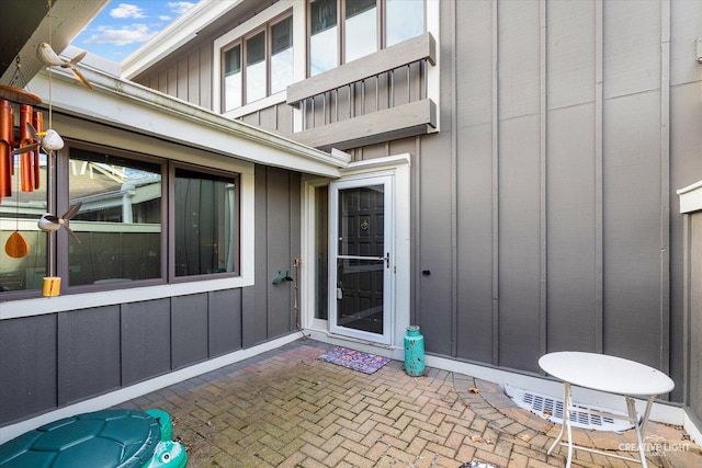 property entrance featuring a patio area