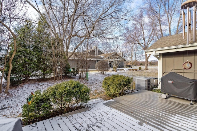 snow covered deck featuring cooling unit