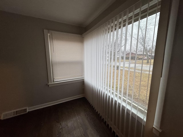 unfurnished room with dark wood-type flooring