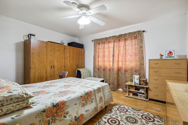 bedroom with light wood-type flooring and ceiling fan