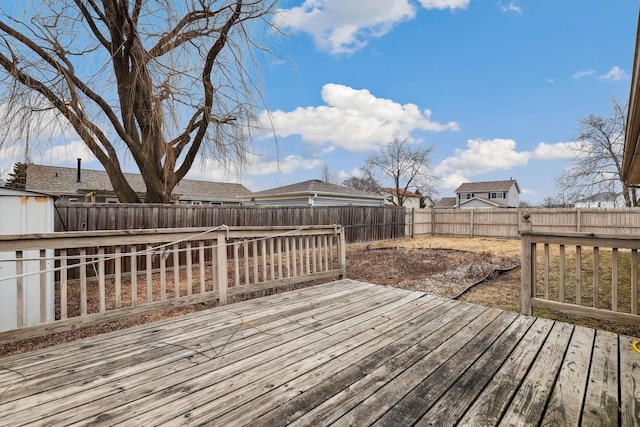 wooden terrace with a fenced backyard