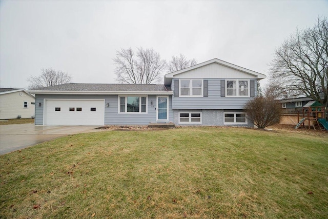 tri-level home featuring a garage, a front yard, and a playground