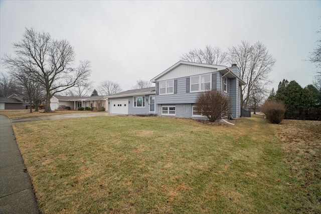 view of front of house featuring a garage and a front lawn