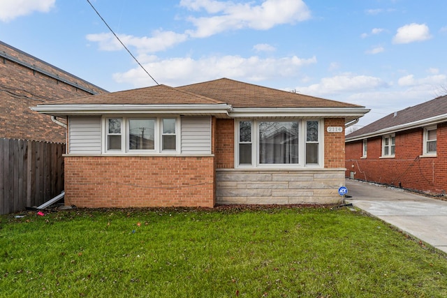 bungalow-style house with a front yard