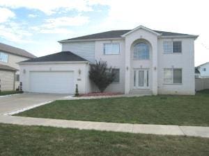 view of front of home featuring a garage and a front lawn