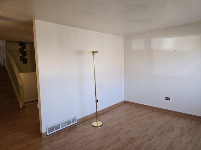 empty room with wood-type flooring