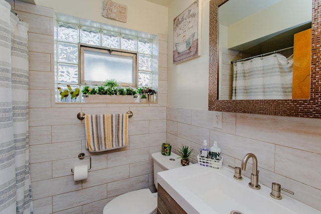 4551 W Foster Ave, Chicago, IL 60630 - bathroom featuring tile walls, vanity, toilet, and a shower with shower curtain