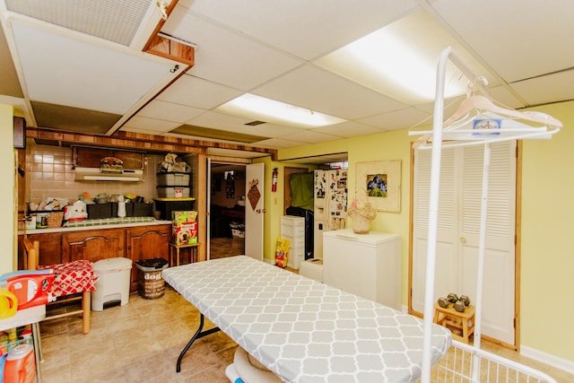 4551 W Foster Ave, Chicago, IL 60630 - kitchen featuring a drop ceiling, light tile patterned floors, white fridge with ice dispenser, and refrigerator