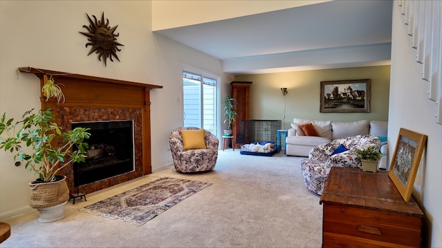 carpeted living room with a tiled fireplace