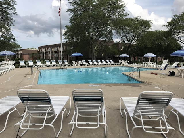 view of swimming pool with a patio