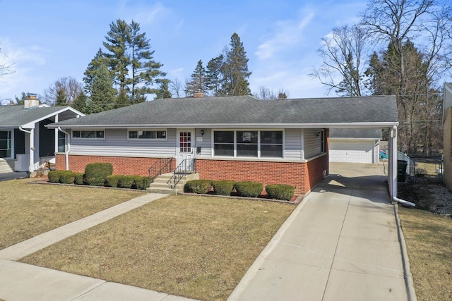 ranch-style home with a front yard, brick siding, driveway, and a shingled roof