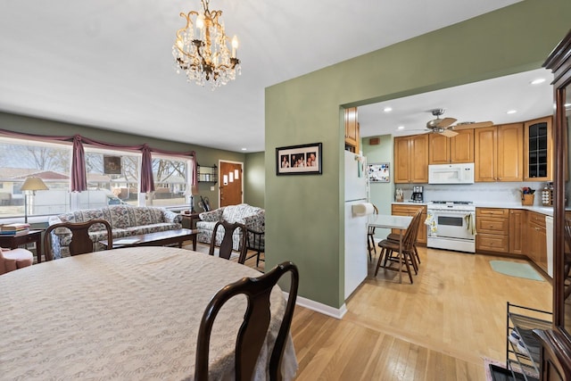 dining room featuring recessed lighting, ceiling fan with notable chandelier, baseboards, and light wood finished floors