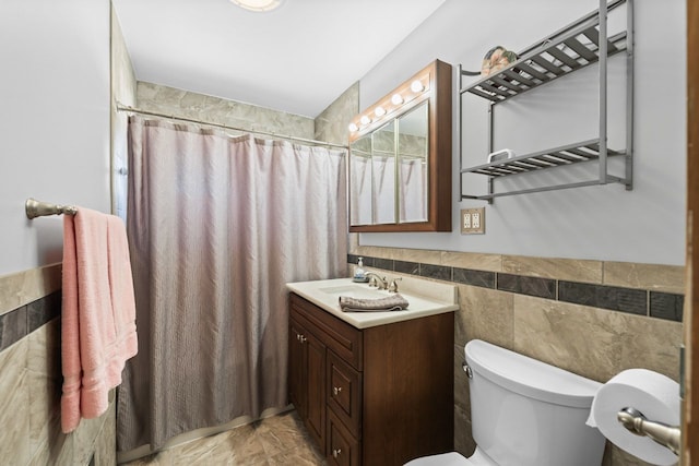 bathroom featuring vanity, tile walls, toilet, and a shower with curtain