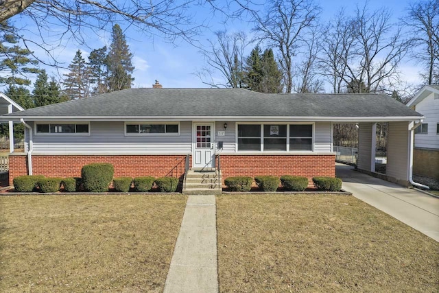 single story home with entry steps, a front yard, a carport, and brick siding