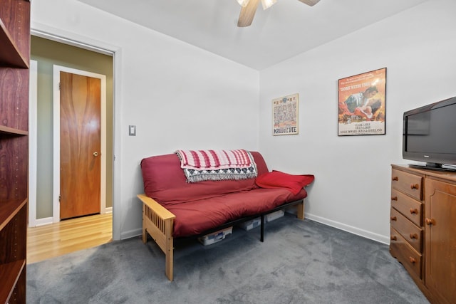 sitting room with baseboards, a ceiling fan, and carpet flooring