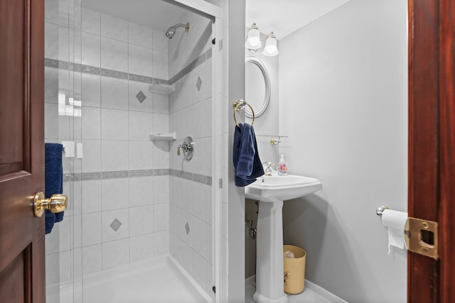 bathroom featuring baseboards and a stall shower