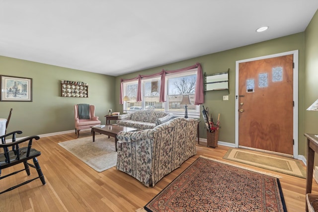 living area featuring recessed lighting, baseboards, and light wood finished floors