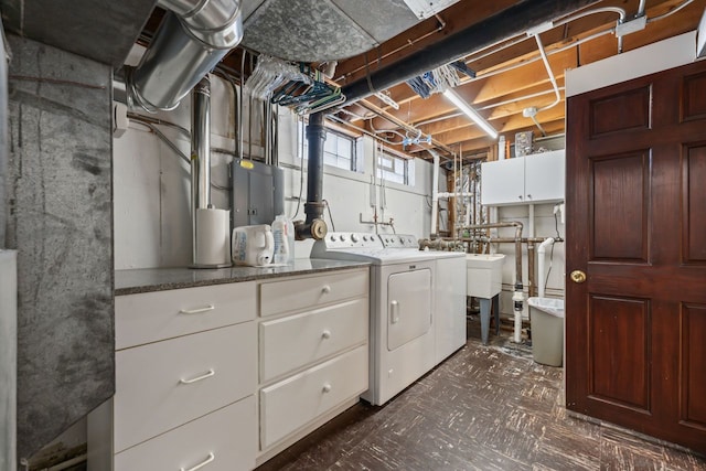 washroom featuring cabinet space and separate washer and dryer