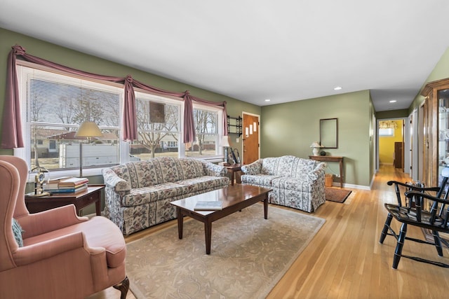 living area featuring recessed lighting, baseboards, and wood finished floors