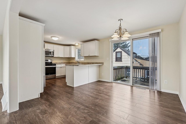 kitchen featuring white cabinetry, stainless steel appliances, dark hardwood / wood-style flooring, kitchen peninsula, and a chandelier