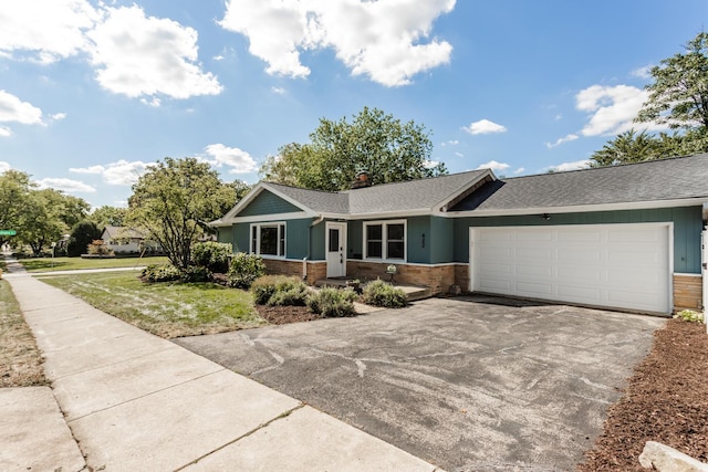 ranch-style house with a garage and a front yard