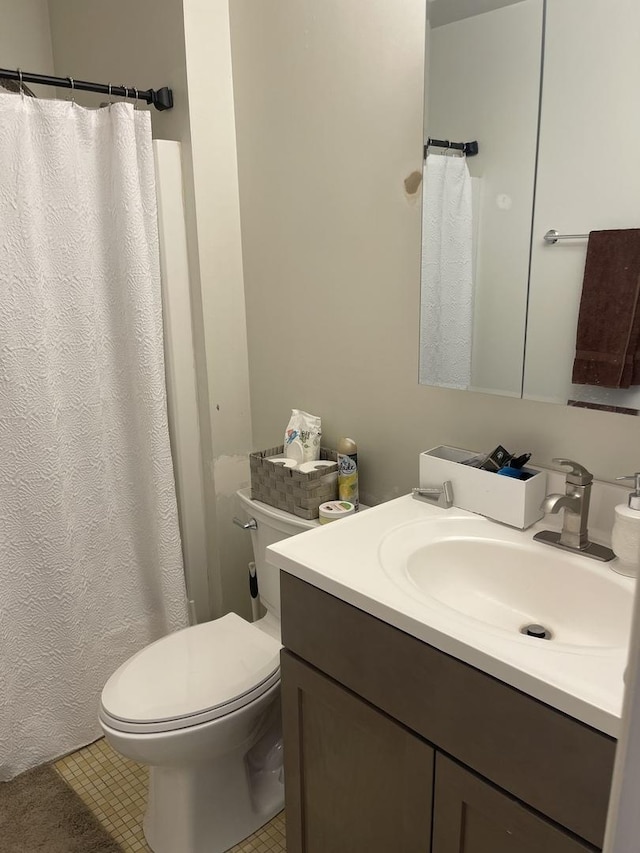 bathroom with vanity, tile patterned floors, and toilet