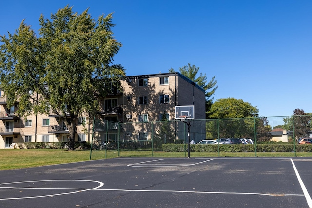 view of basketball court with a yard