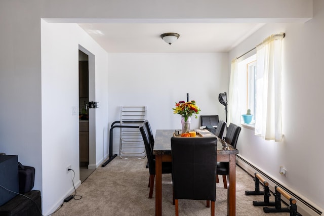 carpeted dining space with a baseboard heating unit