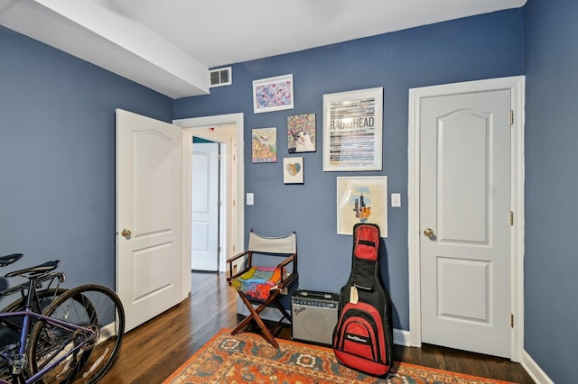 rec room with dark wood-style flooring, visible vents, and baseboards