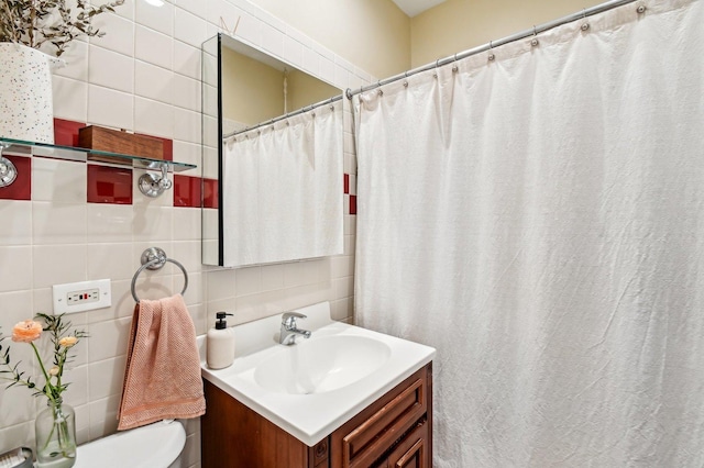 full bathroom with backsplash, toilet, tile walls, and vanity