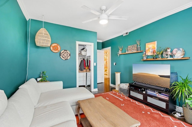 living room featuring a ceiling fan and crown molding